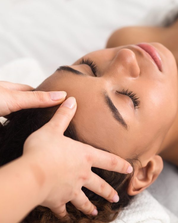 A person getting a facial massage at a spa